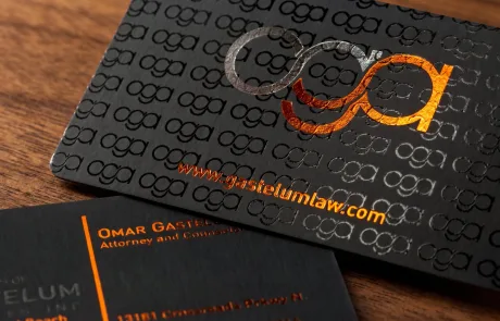Gastelum Law business card in matte black onyx with a repeating silver and copper foil monogram pattern