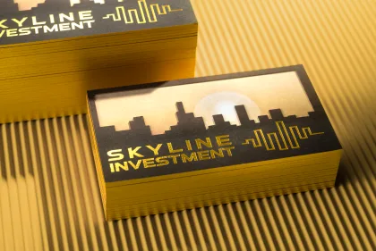 Two stacked Skyline Investment cards with gold foiled edges and a die-cut skyline window.