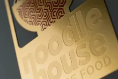 A brushed metal card with a reflective surface.
