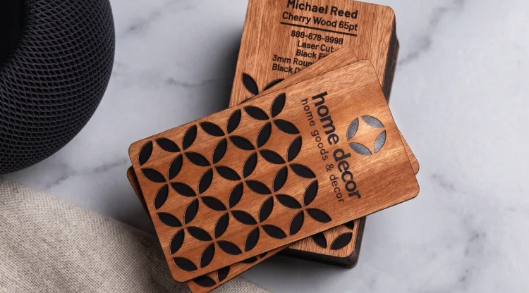 Cherry wood cards for a home goods brand, laser-cut in a repeating floral lattice pattern